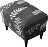 A dark gray ottoman with a white fern leaf pattern, resting on four black legs, against a white background. Produktbild-Vorschau
