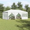 A white party tent with picnic tables inside, set up on a grassy lawn with trees in the background. Podgląd zdjęcia produktu