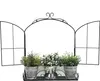 A black metal wall-mounted shelf designed to look like a window, holding three potted plants. Produktbild-Vorschau