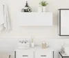 A clean, minimalist bathroom scene featuring a white wall-mounted cabinet. Náhled obrázku produktu