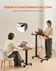 Two people using adjustable standing desks in a room. Náhled obrázku produktu