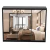 A bedroom scene displayed within a glass enclosure, showcasing a bed and furniture. Produktbild-Vorschau