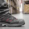 A person wearing a safety shoe in a warehouse. Produktbild-Vorschau