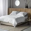 A bedroom scene with a neatly made bed. Produktbild-Vorschau