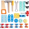 A collection of wooden toy tools and construction pieces arranged on a white background. Produktbild-Vorschau