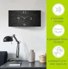 A wall clock with a granite-like texture and silver hands is displayed on a white wall above a desk with a lamp and a vase. To the right, there are marketing icons and text describing the product's features. Produktbild-Vorschau