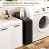 A narrow black cabinet is placed next to a washing machine and a white sink unit, with various toiletries on the sink. Náhled obrázku produktu