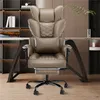A khaki ergonomic office chair with a headrest and lumbar support is shown in a home office setting. Voir les images du produit