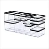 A collection of clear plastic food storage containers with black lids, arranged in rows. Produktbild-Vorschau