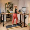 A woman is using a treadmill desk in a home office setting. Produktbild-Vorschau