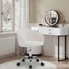 A vanity chair and desk set in a room with a window view of a snowy landscape. Produktbild-Vorschau