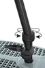 A close-up view of a black plastic connector attached to a gray grate-like surface, with arrows indicating rotation. Produktbild-Vorschau