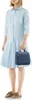 A woman is holding a blue toiletry bag. Produktbild-Vorschau