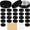 A collection of black aluminum tins with silver interiors and lids, arranged in rows, with a sheet of round stickers and four small white spatulas at the bottom. Produktbild-Vorschau