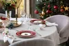 A festive Christmas table setting with plates, glasses, and a Christmas tree in the background. Voir les images du produit