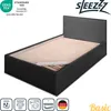 A black bed frame with a beige mattress base, shown from a slightly elevated angle against a white background. Náhled obrázku produktu