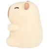 A side view of a cream-colored, soft silicone night light shaped like a capybara. Náhľad obrázku produktu