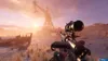 A first-person perspective of a video game scene, showing a weapon in the foreground and a post-apocalyptic landscape with a crane and a shipwreck in the background. Produktbild-Vorschau