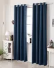 A room interior with dark blue curtains covering a window, a white dresser with decorative items, and a lamp. Produktbild-Vorschau