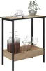 A side table with a decanter and glasses on the lower shelf, and a book, cup, and plant on the top shelf. Produktbild-Vorschau