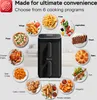 A black air fryer is shown in the center, surrounded by plates of food representing different cooking programs. Náhľad obrázku produktu