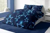 A bedroom scene with a bed made up with dark blue bedding featuring glowing blue stars. Produktbild-Vorschau
