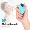 A hand holding a small blue electronic device with a display, with a blurred image of a woman sleeping in the background. Produktbild-Vorschau