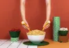 Hands holding pasta servers over a bowl of spaghetti, with bowls of cherries and mushrooms nearby. Náhľad obrázku produktu