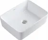 A white ceramic washbasin with a silver drain. Podgląd zdjęcia produktu