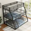 A triple bunk bed with metal frame and mattresses in a room with a window. Podgląd zdjęcia produktu