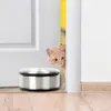 A cat peeks around a door frame next to a stainless steel door stopper. Voir les images du produit