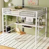 A white metal loft bed with an integrated desk and shelves, set up in a room with light green walls and a patterned rug. Produktbild-Vorschau