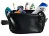 A black toiletry bag filled with various personal care items and a smartphone. Produktbild-Vorschau