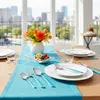 A dining table set for a meal with cutlery, plates, glasses, a fruit bowl, and a floral arrangement. Anteprima dell’immagine prodotto