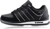 A side view of a black K-Swiss sneaker with white accents. Voir les images du produit