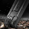 A rugged black phone case is shown in a dramatic, debris-filled setting, suggesting durability and protection. Náhled obrázku produktu