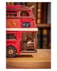 A close-up of a wooden model of a red double-decker London bus, with books in the background. Náhľad obrázku produktu
