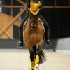 A person riding a horse in an indoor arena. Voir les images du produit