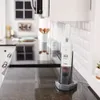 A handheld vacuum cleaner is shown charging on a kitchen counter. Produktbild-Vorschau