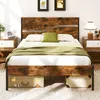 A bedroom scene with a bed, nightstands, and artwork on the wall. Podgląd zdjęcia produktu