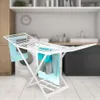 A white foldable drying rack with towels hanging on it, placed in a laundry room setting. Produktbild-Vorschau