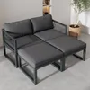 A modern, modular outdoor seating set with gray cushions and a woven rope detail on the arms, placed on a concrete floor next to a potted plant. Produktbild-Vorschau