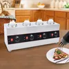 A commercial sauce warmer with four dispensers sits on a wooden table, with a crepe being drizzled with chocolate sauce in the foreground. Náhled obrázku produktu