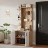 A hallway or entryway with a wooden and white storage unit, a plant, and a door. Produktbild-Vorschau