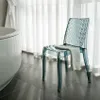 A transparent blue chair with a towel draped over it, placed next to a bathtub in a bathroom. Anteprima dell’immagine prodotto