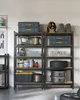 A storage unit with various items on shelves in a garage or workshop. Produktbild-Vorschau