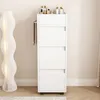 A white standing cosmetics rack with bottles on top, next to a tall white floor lamp. Produktbild-Vorschau