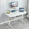 A white adjustable standing desk with a monitor, laptop, and accessories. Anteprima dell’immagine prodotto