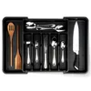 A black cutlery organizer filled with various utensils and a knife, placed on a white background.