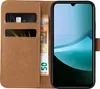 A brown flip-case wallet for a smartphone, with a smartphone inserted. The wallet has slots for cards and cash. Produktbild-Vorschau